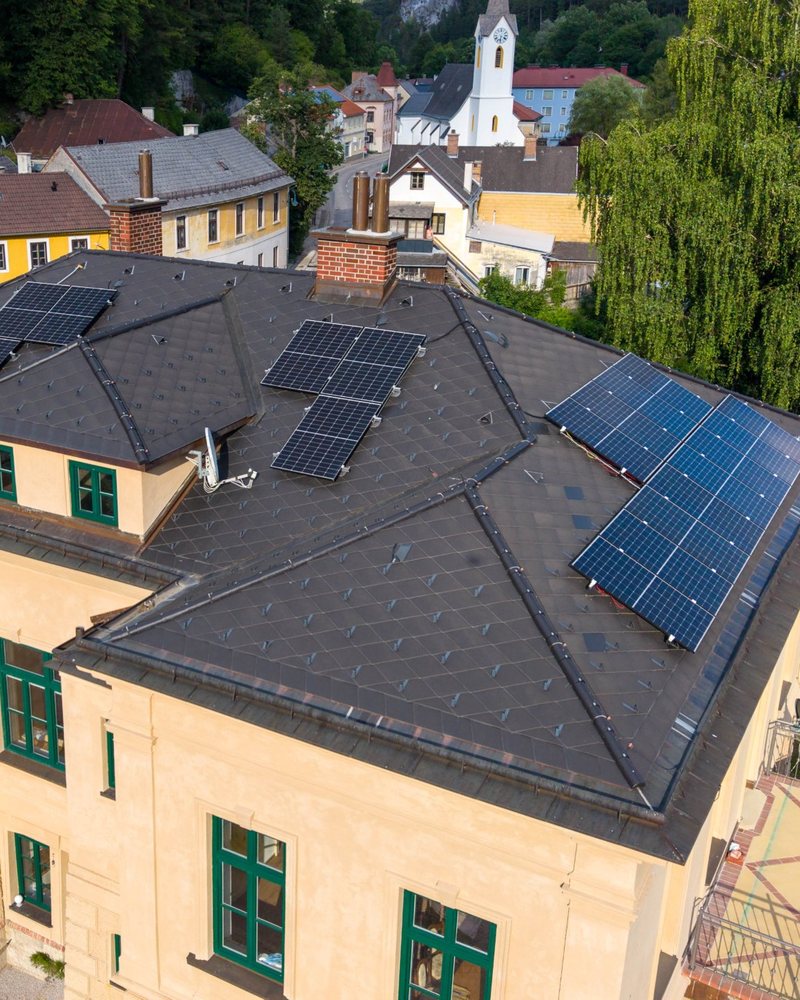 Anzeige mit Luftbild einer Villa mit neuem Dach und Photovoltaik